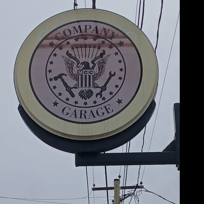 Round MCC Company Garage sign